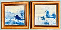 Pair of blue and white Delft tile plaques in wooden frames shown side by side