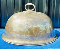 Dome-shaped antique silver plate meat cover with raised Leith maker's mark on side and an oval handle on top.