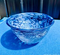 Side view of the vintage art glass bowl showing swirled blue and white pattern and shape