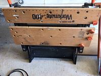 Top view of the wooden work surface with 'Workmate 400' logo and visible scratches and marks