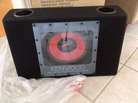 Front view showing the Kenwood logo, model number, and transparent panel on the speaker enclosure.
