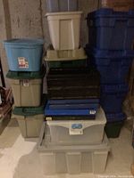 Front view of stacked assorted plastic storage containers and crates