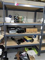 Full view of metal framed shelving unit with items on shelves showing overall size and construction.