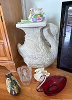 Wide view of the swan pedestal and all items arranged on floor and pedestal