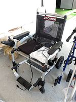 Full view of Zoomer power folding mobility chair in garage setting