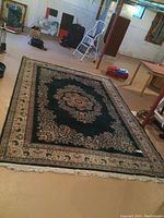 Full view of rug laid out on basement floor