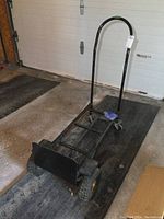 View of the metal convertible hand cart from front angle showing handle and loading plate.