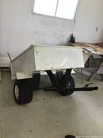 Side/front view of trailer showing bed, frame and tires