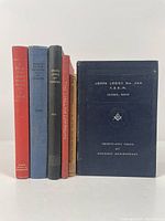 Photo of six masonry-related books upright, titles visible showing variety of colors and styles