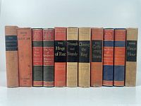 Front-facing group photo of 11 books mostly by Winston Churchill on WWII, arranged by height showing titles and author names on spines.