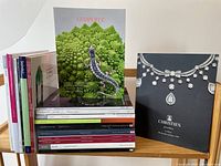 Stack of jewelry catalogues showing front covers and spines with different auction houses and dates.