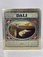 Front cover of the Dali book showing gold cover with Salvador Dali painting and title