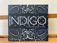 Front cover of the Indigo book showing the title and decorative indigo paisley patterns.
