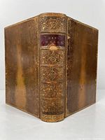 Photo of the book with spine visible showing the title 'Ben Jonson' on a red leather label with gold tooling on the spine and decorative embossing on full leather binding.