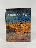 Front cover of the art book showing Van Gogh's 'Wheatfield with Crows' painting on the dust jacket.