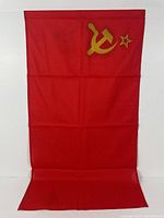 Front view of red USSR flag with hammer and sickle symbol