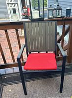 Outdoor chair on deck with red cushion