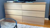 Front angle view of the pressed wood 6-drawer dresser showing its clean modern lines and light wood finish.