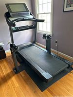 Full front view of NordicTrack treadmill showing the running belt, console with 22-inch touchscreen, and handles with heart rate sensors.