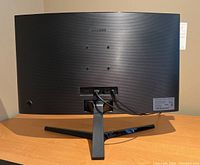 Rear view of Samsung monitor showing curved backside and stand