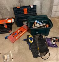 Overview of various toolboxes, bins, and hand tools as seen in the lot, showing the mix of items included such as level, ratchet set, and tapes