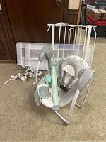 Photo of baby gate, baby swing with tunes, and bed side rails arranged together