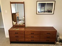 Front view of teak dresser showing nine drawers and attached mirror