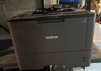 Front view of Brother HL-L5200DW printer showing Brother logo and general condition.