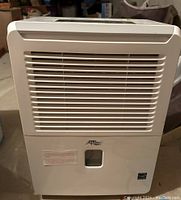 Front view of white Cool Works humidifier showing vents, water level window, and branding.