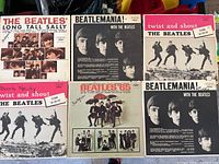 Six Beatles LPs arranged in two rows showing cover artwork and titles.