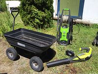 All three items on gravel: cart, pressure washer, blower and battery charger