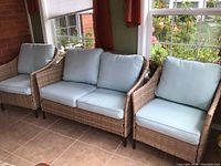 Three-piece seating arrangement: two armchairs flanking a two-seat loveseat