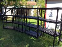 Overview of eight assembled shelving units outdoors
