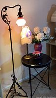 Full view of floor lamp, table lamp, table, vase, and ceramic pot