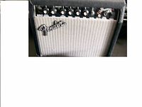 Image showing Fender 15R guitar amplifier front with silver grille and multiple control knobs on top, leftmost knob missing.