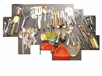 Photo of 74 pieces of assorted household utensils laid out on a dark surface.