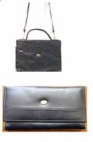 Photo of black genuine leather purse with handle and shoulder strap and matching black leather bill fold wallet.
