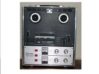 Front view of Panasonic RS-755S reel-to-reel tape deck showing reel spindles, control knobs, VU meters, and labeling detail.