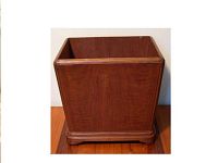 Straight-on view of solid wood plant box showing rectangular shape and raised base with molding detail.