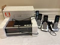 Candle electronic clock radio JCR-387 with original box and four VTech cordless landline phones with charging bases and cords