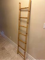 Full view of the bamboo decorative ladder showing height, width, and all five rungs.