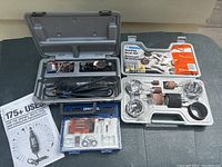 Overview of the Dremel Moto-Tool with accessories and the rubber sanding drum set displayed on a gray surface.