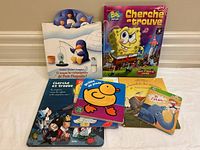Six French children's books arranged on a white surface. Books include Bob lponge Cherche et Trouve, Petit Pingouin interactive book, and more.