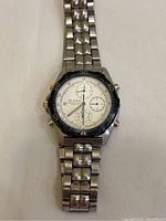 Front view of Seiko men's chronograph wristwatch with stainless steel band and white dial with multiple subdials.