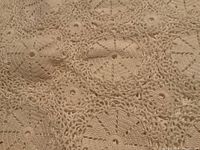 Close-up of the crocheted circular lace pattern showing detailed stitches and open spaces.