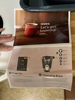 Instruction manual page for Keurig K-Elite Coffee Maker showing brewing instructions and control panel details.