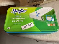 Swiffer Wet Mopping Cloths sealed container with fresh scent and Trap + Lock technology