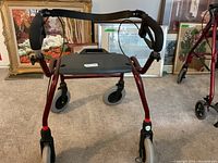 Front view of the red Dolomite walker rollator with four wheels, padded handles, and seat.