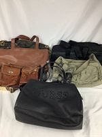 Overview of all five purses in lot showing different styles and brands.
