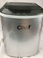 Front view of silver Master Chef ice maker showing branding and overall exterior condition.